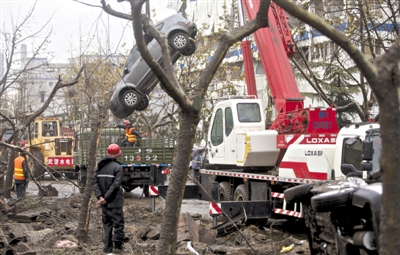 输油管道爆炸后，抢修人员将被炸毁的车辆运出现场。