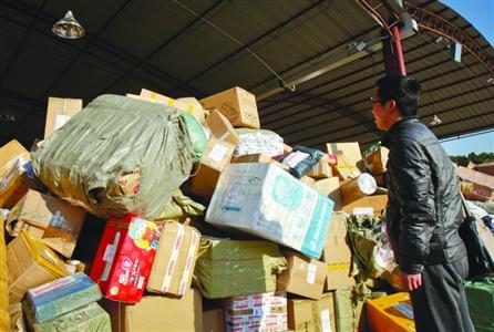 看着堆积如山的快件，前来找寻自己快件的客户一筹莫展。