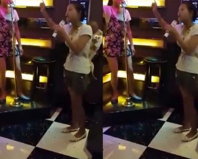 女子背着孩子KTV内忘情嗨歌 手舞足蹈