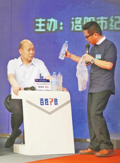 在现场，问政嘉宾向陈亚利展示浑浊的井水。